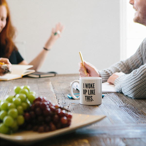 Clever's kitchen table, two project managers planning over coffee and grapes